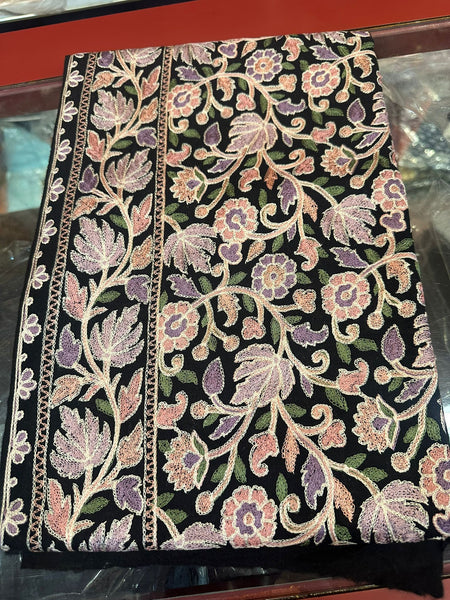 Decorative fabric with floral patterns on a black background. 